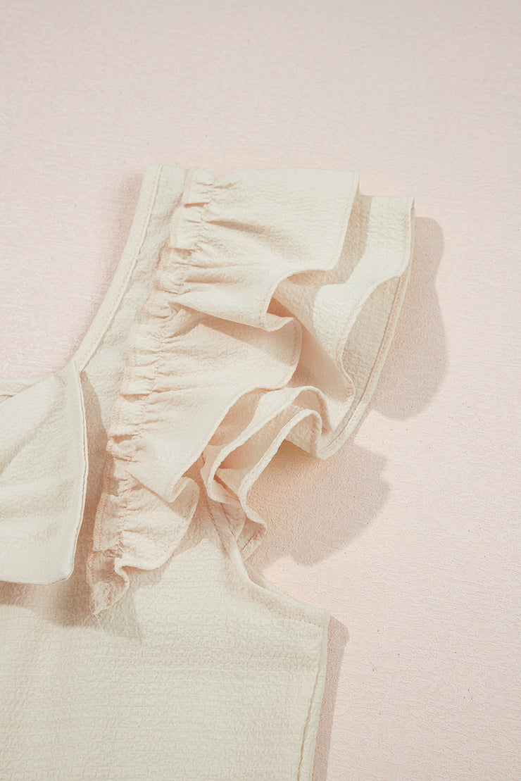 Blusa beige texturizada con lazo, volantes y mangas mariposa