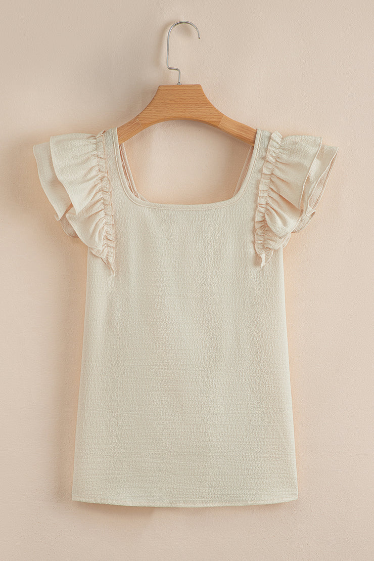 Blusa beige texturizada con lazo, volantes y mangas mariposa
