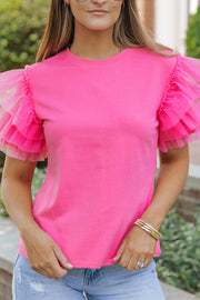 Blusa de tul rosa con mangas con volantes