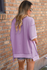 Top de media manga asimétrico con costuras expuestas y pétalos de orquídea