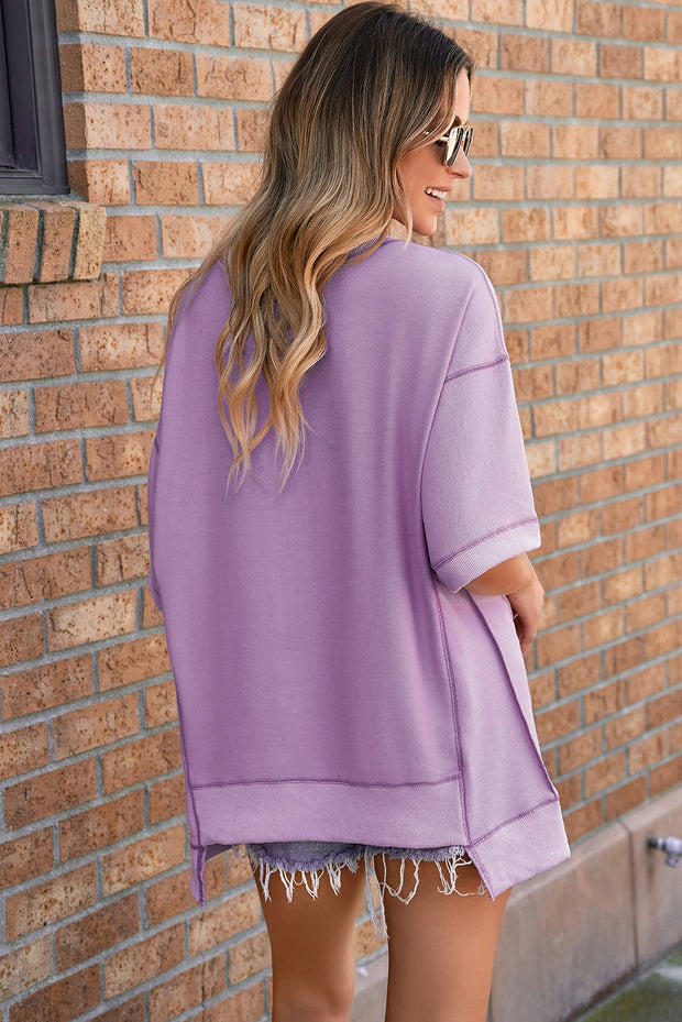 Top de media manga asimétrico con costuras expuestas y pétalos de orquídea