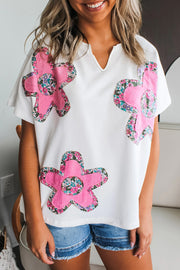 Blusa con cuello en V, mangas dolman y apliques florales blancos