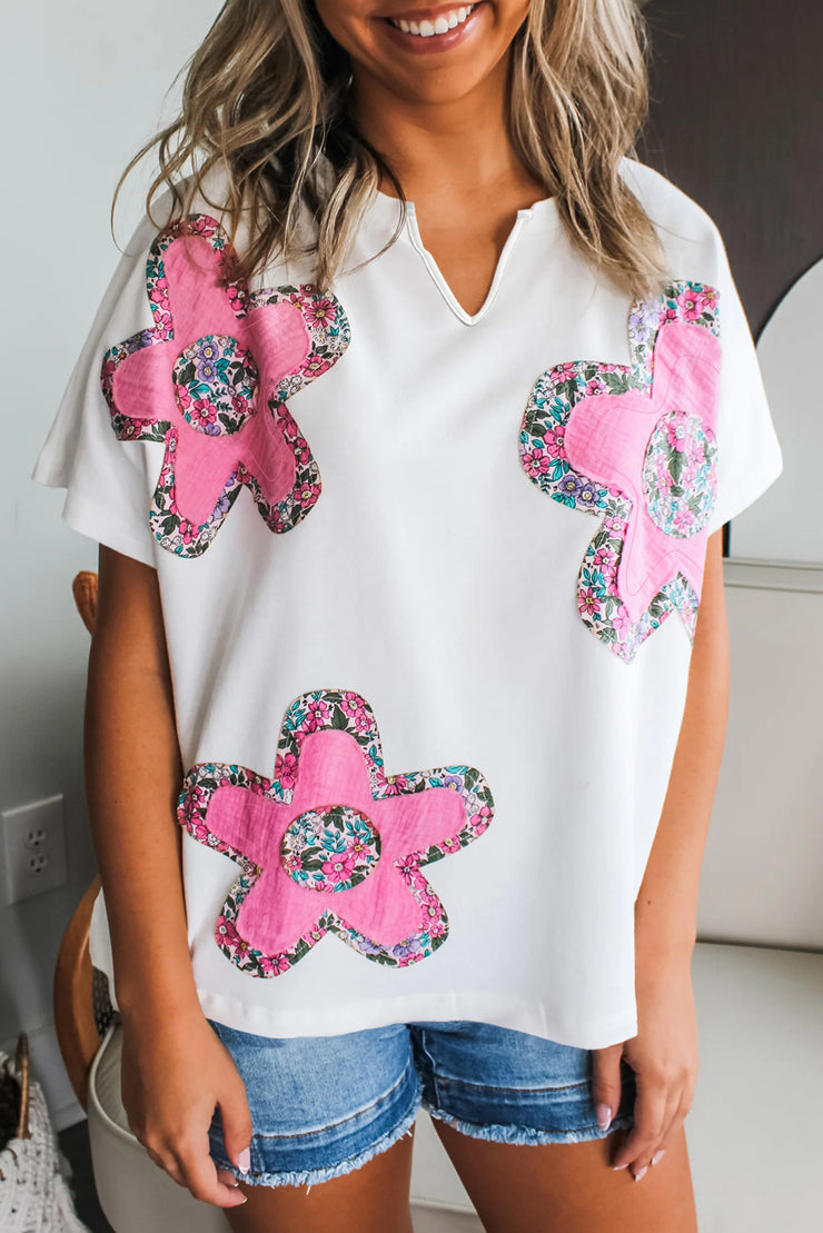 Blusa con cuello en V, mangas dolman y apliques florales blancos
