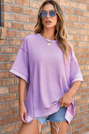 Top de media manga asimétrico con costuras expuestas y pétalos de orquídea