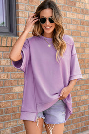 Top de media manga asimétrico con costuras expuestas y pétalos de orquídea