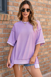 Top de media manga asimétrico con costuras expuestas y pétalos de orquídea